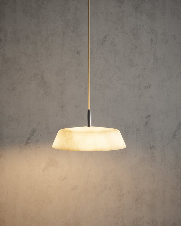 Robin Lamps Bonn alabaster pendant lit against a concrete wall
